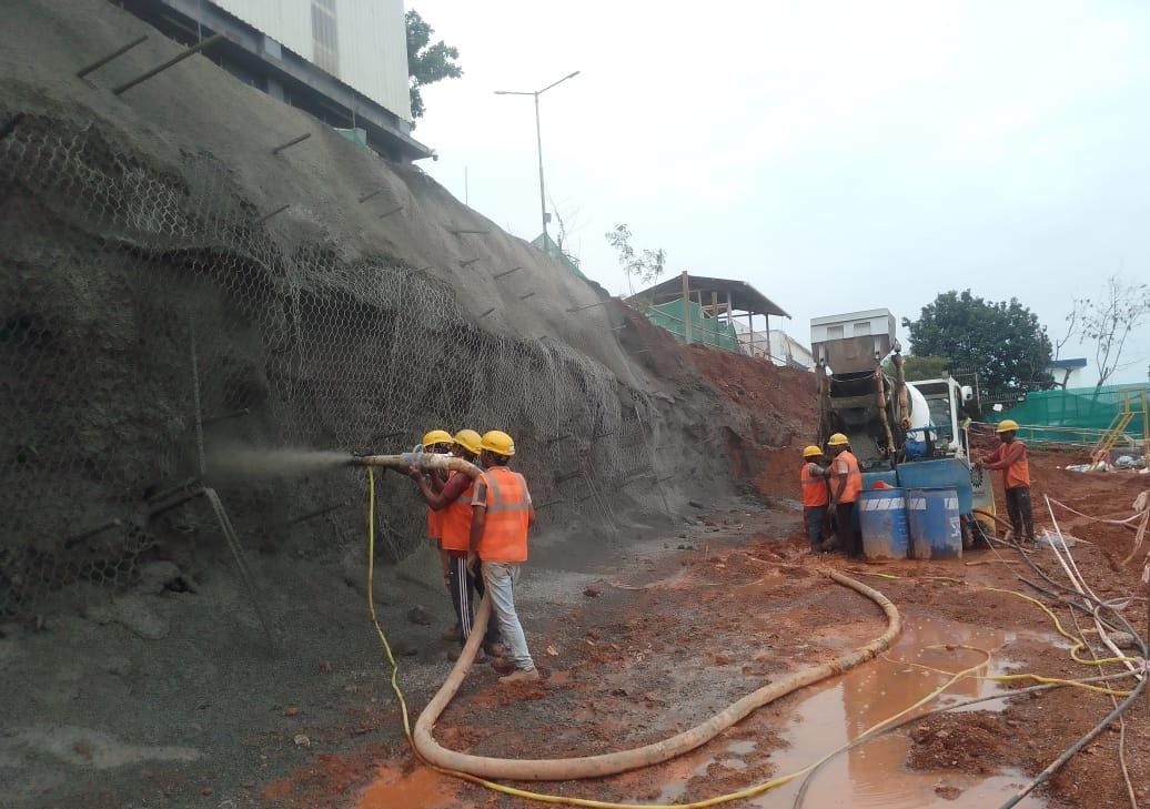 Placing wet shotcrete in slope protection for MV2 Siemens Ltd construction project in Verna, Goa